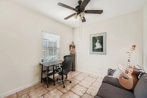 a kitchen with granite countertop a stove top oven a sink dishwasher a dining table and chairs with wooden floor