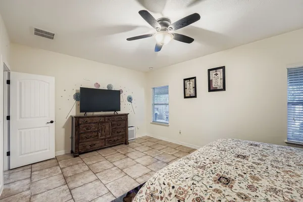 a bedroom with a bed and painting on the wall