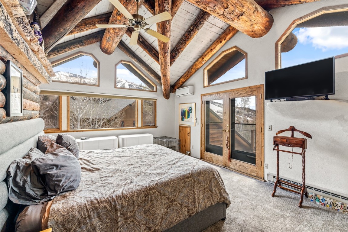 2350 Glacier Ridge Steamboat Springs, CO 80487 - Photo 20 of 47 a bedroom with a large bed and a flat tv screen on dresser