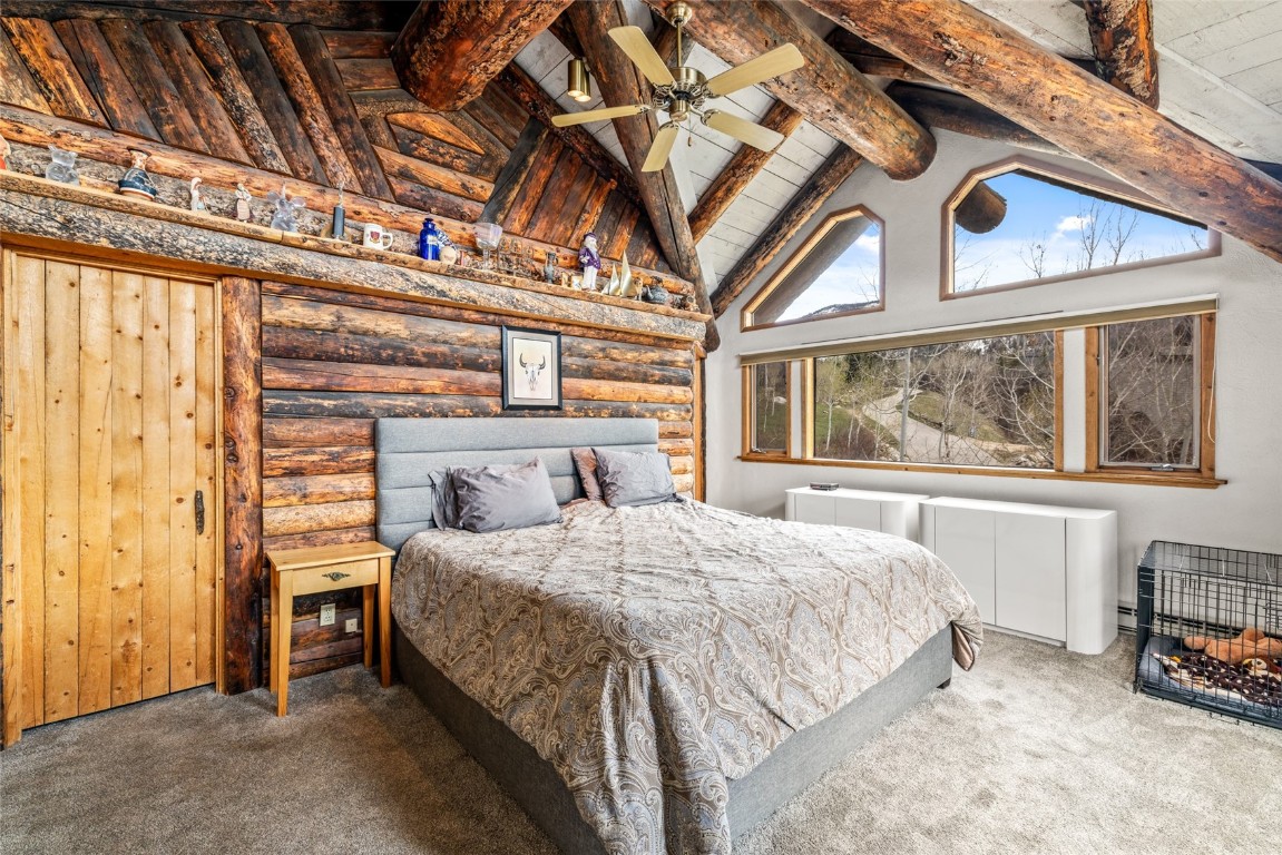 2350 Glacier Ridge Steamboat Springs, CO 80487 - Photo 21 of 47 a bedroom with a bed and a large window