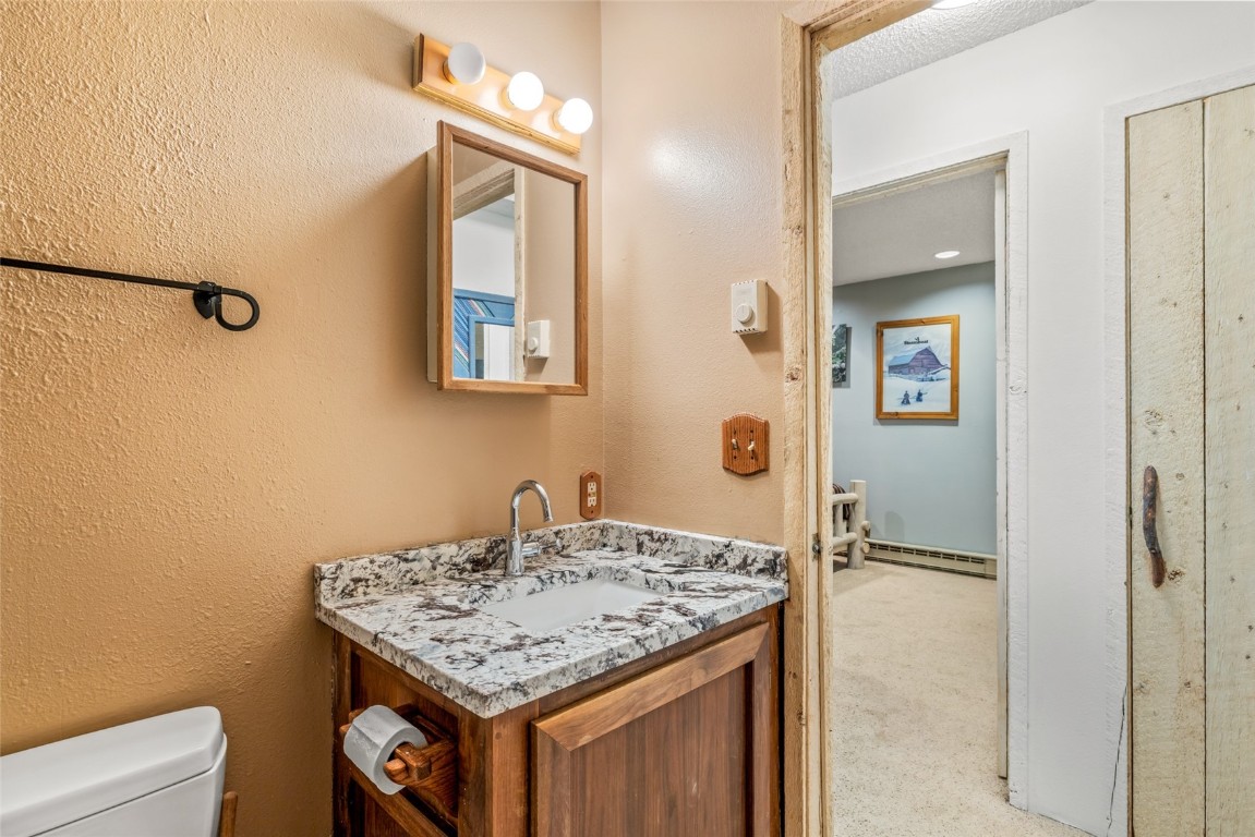 2350 Glacier Ridge Steamboat Springs, CO 80487 - Photo 33 of 47 a bathroom with a granite countertop sink and a mirror