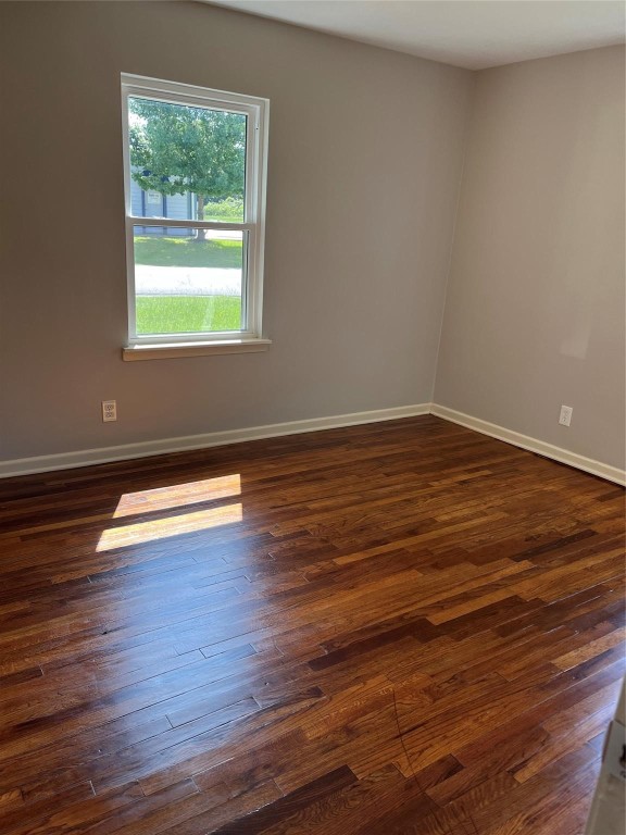 104 Peach Street Tomball, TX 77375 - Photo 13 of 19 a view of empty room with wooden floor and window