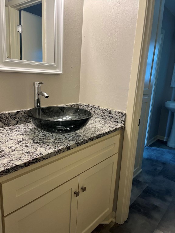 104 Peach Street Tomball, TX 77375 - Photo 14 of 19 a bathroom with a granite countertop sink and a mirror