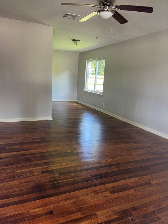 104 Peach Street Tomball, TX 77375 - Photo 4 of 19 wooden floor in an empty room with a window