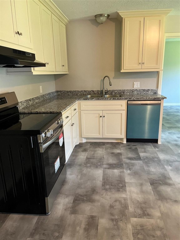 104 Peach Street Tomball, TX 77375 - Photo 7 of 19 a kitchen with granite countertop a sink a stove and cabinets