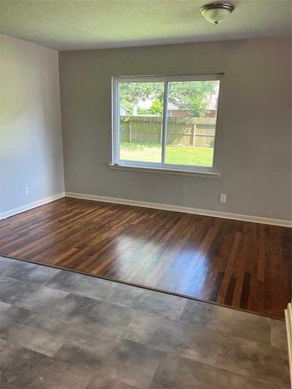 104 Peach Street Tomball, TX 77375 - Photo 10 of 19 an empty room with wooden floor and windows