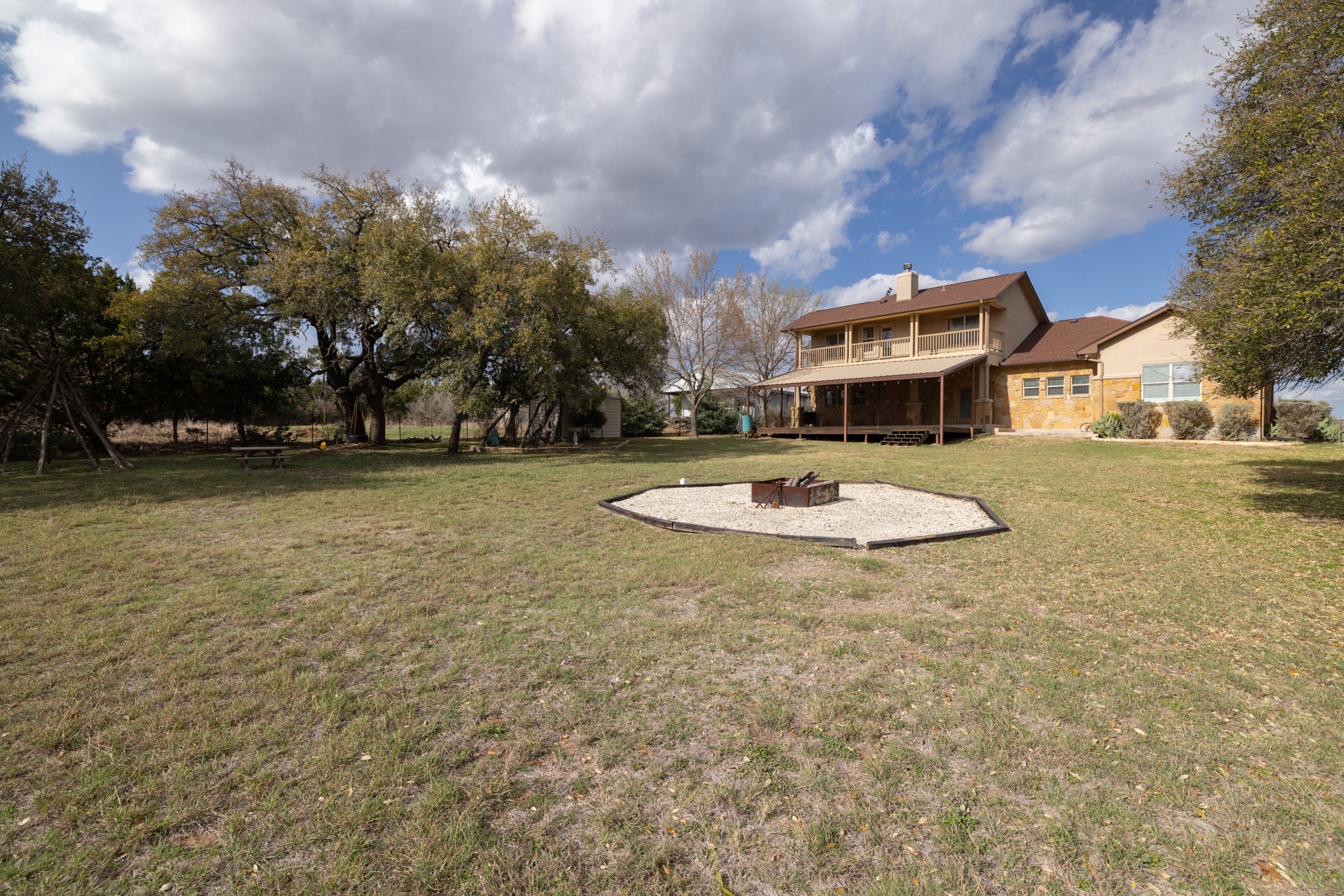 204 Skyline Road Georgetown, TX 78628 - Photo 37 of 40 View of green lawn with an outdoor fire pit and a patio area
