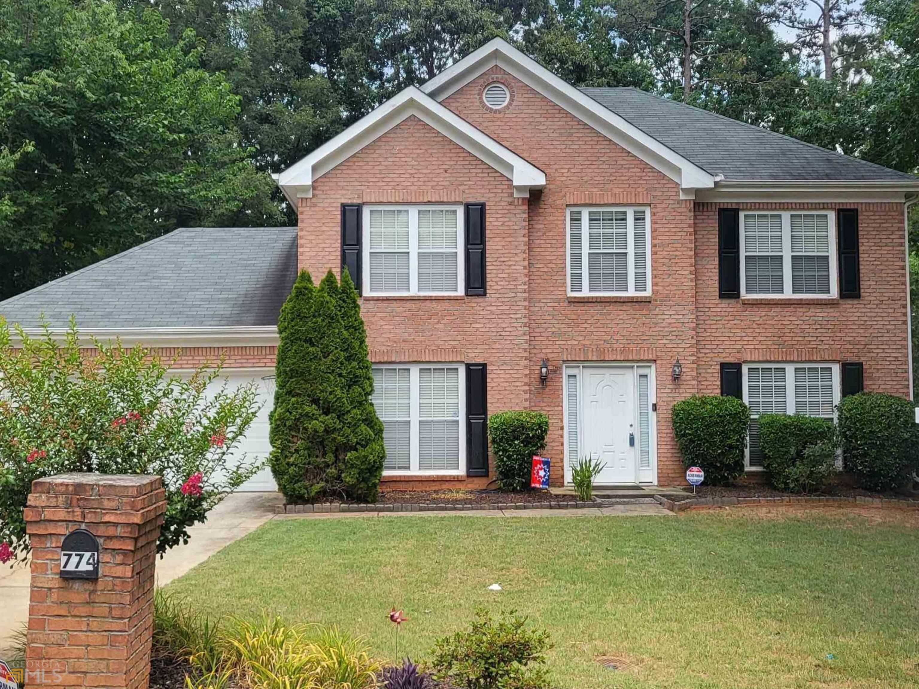 774 Stephenson Ridge Stone Mountain, GA 30087 - Photo 1 of 1 a front view of a house with a yard and garage