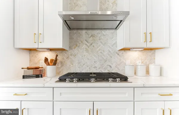 a kitchen with stove and cabinets