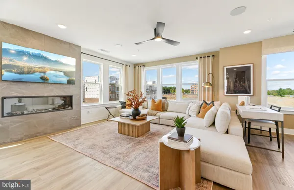 a living room with fireplace furniture and a large window