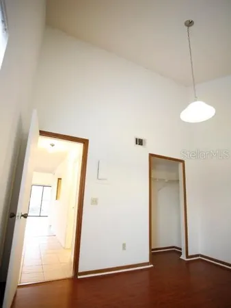 a view of a room with wooden floor and windows