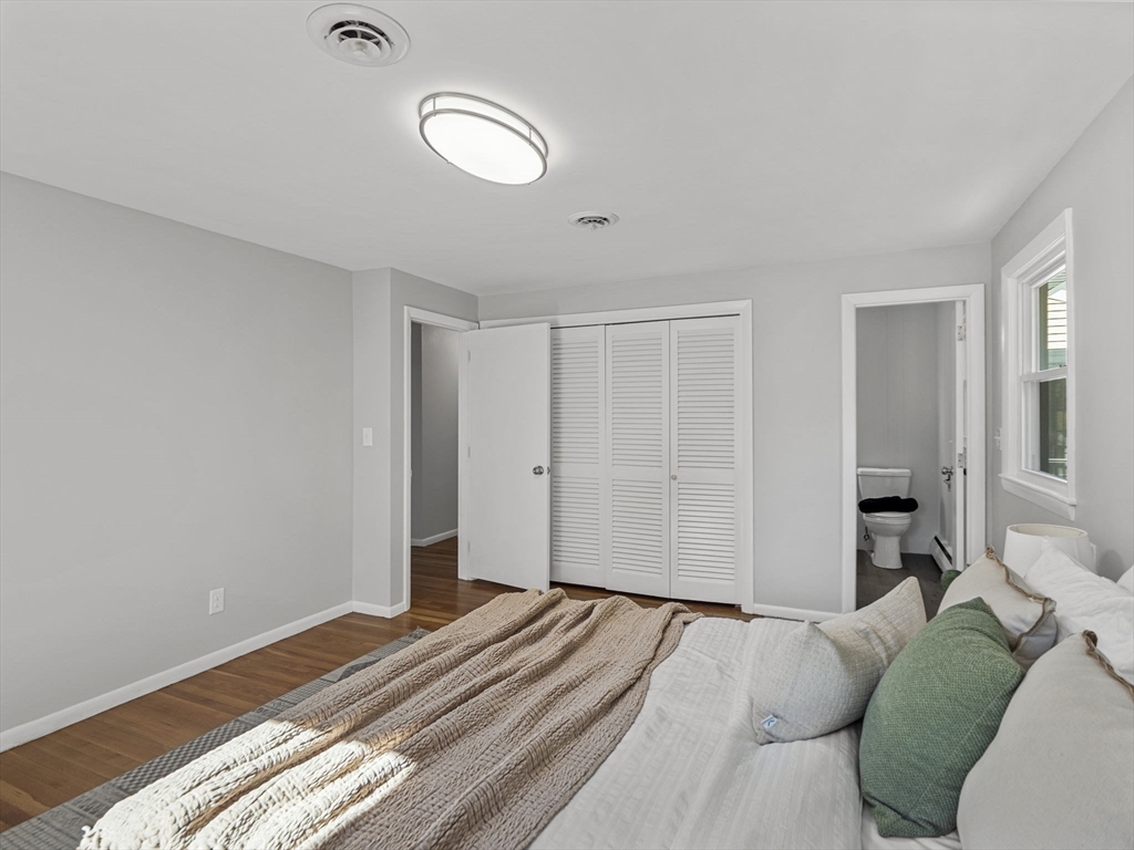 33 Fox Hill Road Framingham, MA 01701 - Photo 14 of 34 a bedroom with a bed and a chandelier