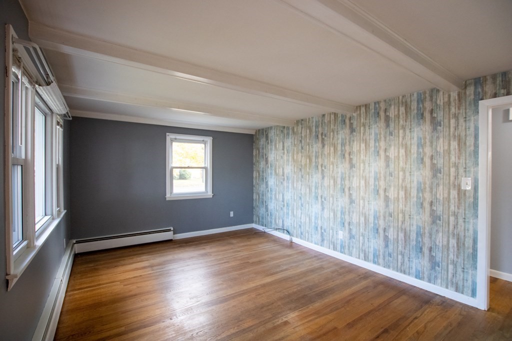 146 Davis Street Springfield, MA 01104 - Photo 3 of 15 an empty room with wooden floor and windows