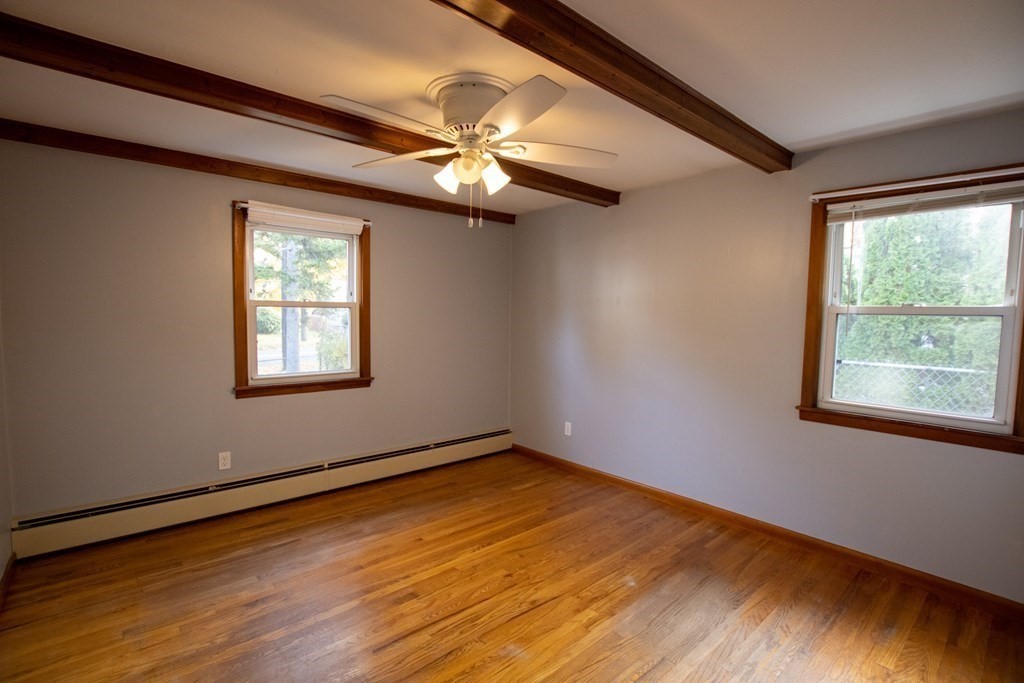 146 Davis Street Springfield, MA 01104 - Photo 4 of 15 a view of an empty room with wooden floor and a window