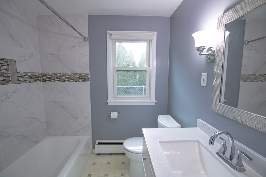 146 Davis Street Springfield, MA 01104 - Photo 5 of 15 a bathroom with a sink a toilet and shower