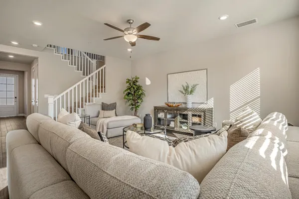 a living room with furniture and a chandelier