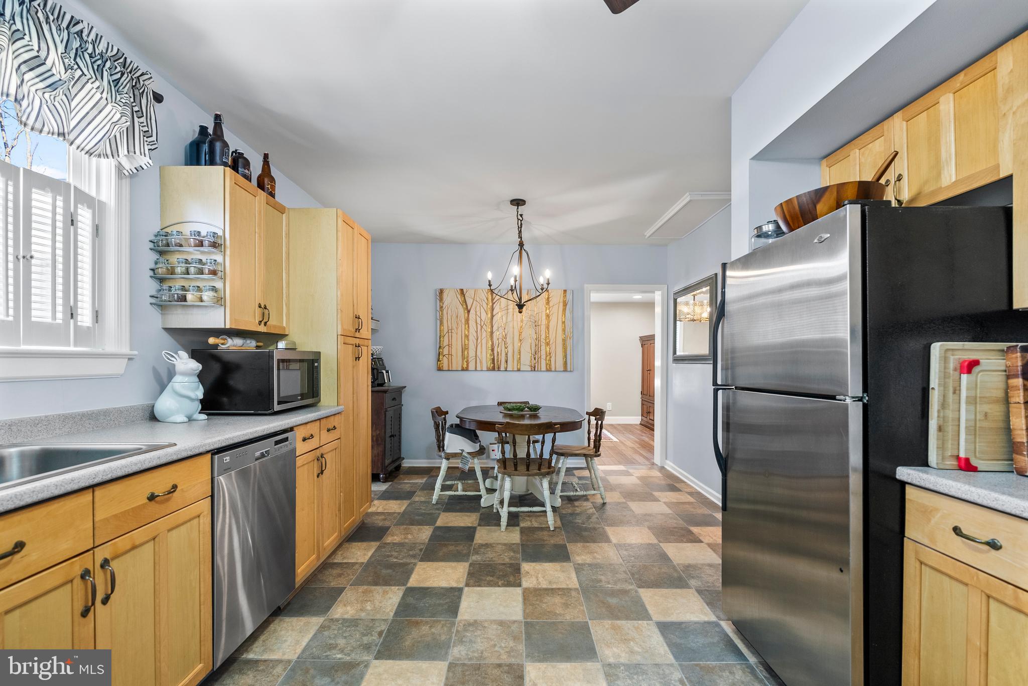 41 Pine Street Beverly, NJ 08010 - Photo 11 of 31 a kitchen with stainless steel appliances a dining table chairs and granite counter tops
