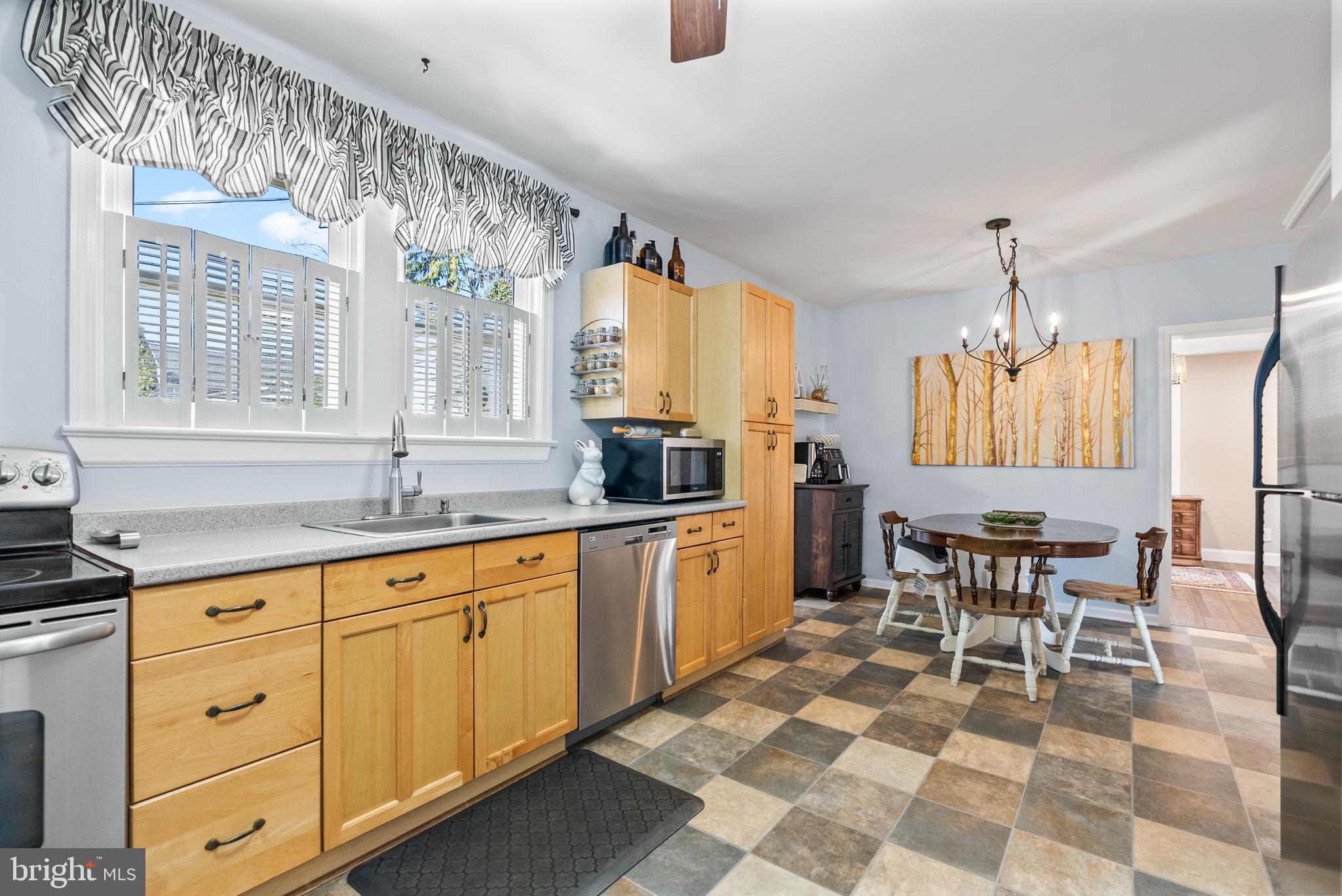 41 Pine Street Beverly, NJ 08010 - Photo 9 of 31 a kitchen with a sink and chairs