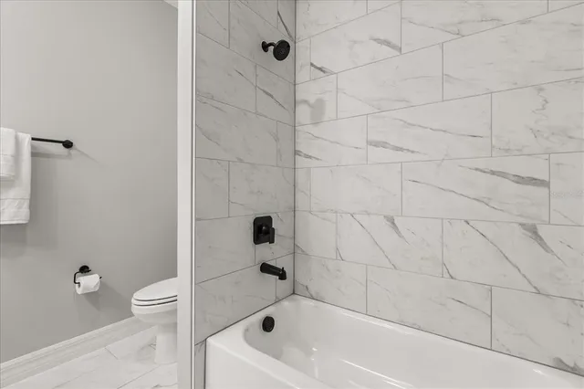 a bathroom with a bathtub and a toilet