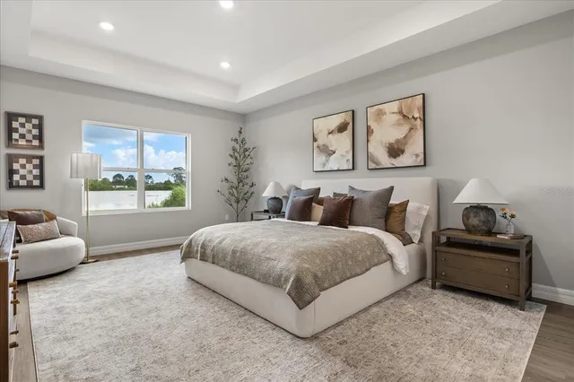 a spacious bedroom with a bed and glass window