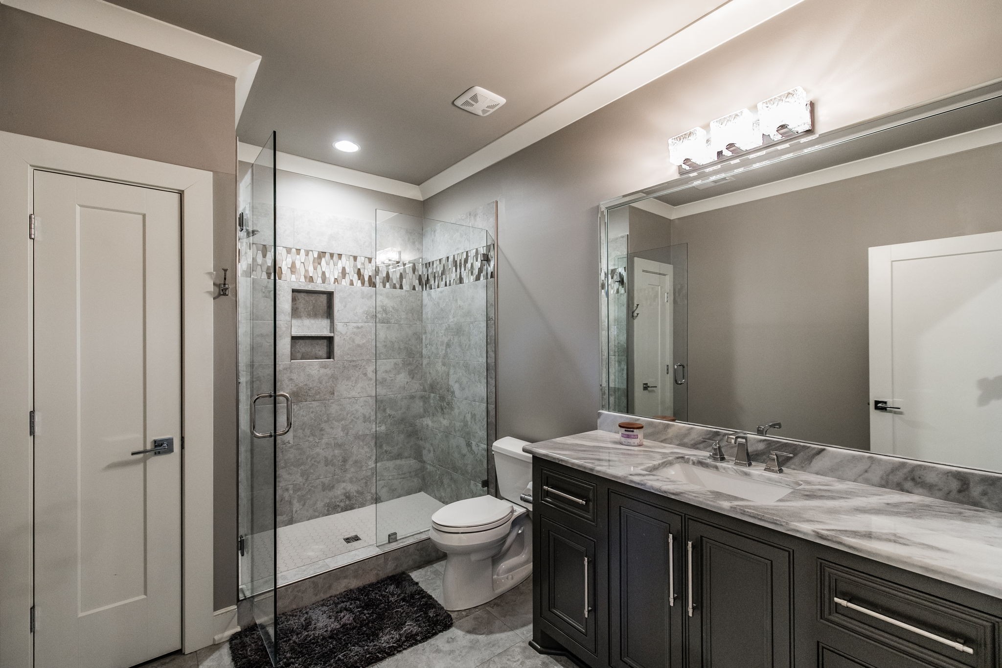 1032 Kendras Run Gallatin, TN 37066 - Photo 30 of 48 a bathroom with a granite countertop sink a toilet a mirror and shower