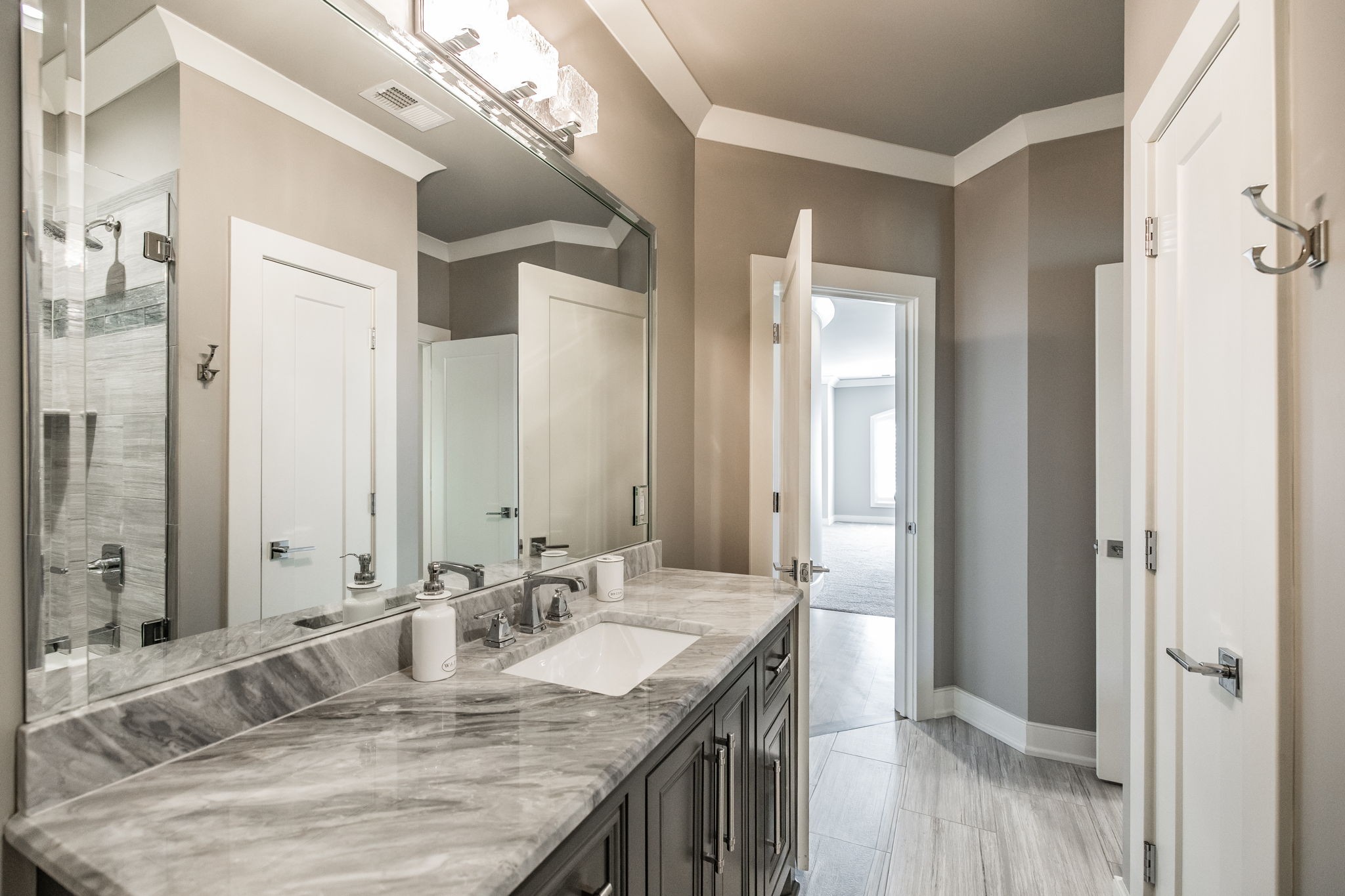1032 Kendras Run Gallatin, TN 37066 - Photo 33 of 48 a bathroom with a granite countertop sink a large mirror and a shower