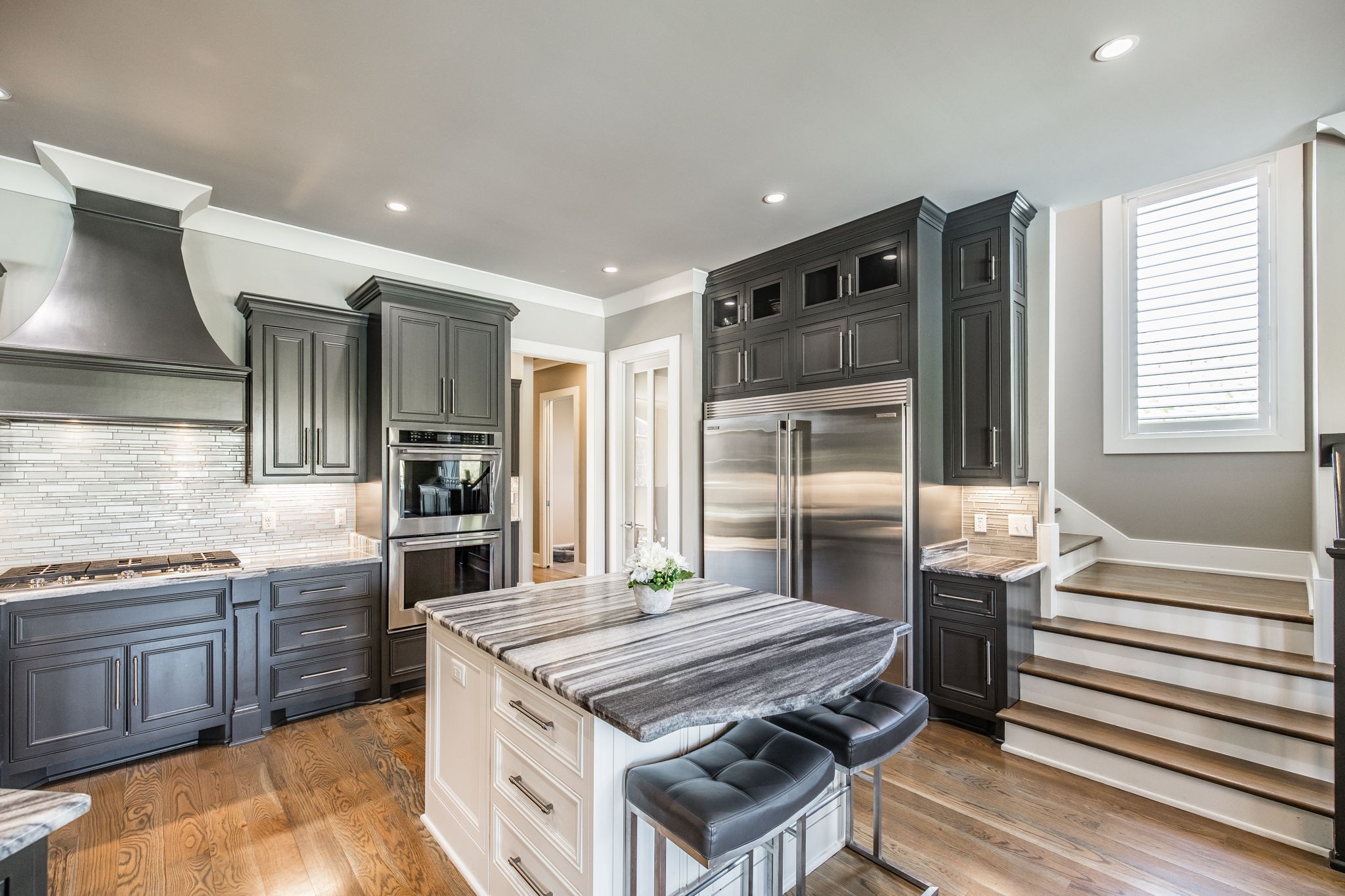 1032 Kendras Run Gallatin, TN 37066 - Photo 10 of 48 a kitchen with kitchen island a sink stove and wooden cabinets