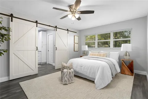 a bedroom with a bed and a chandelier