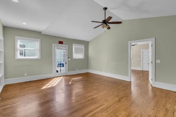 wooden floor in an empty room with a window
