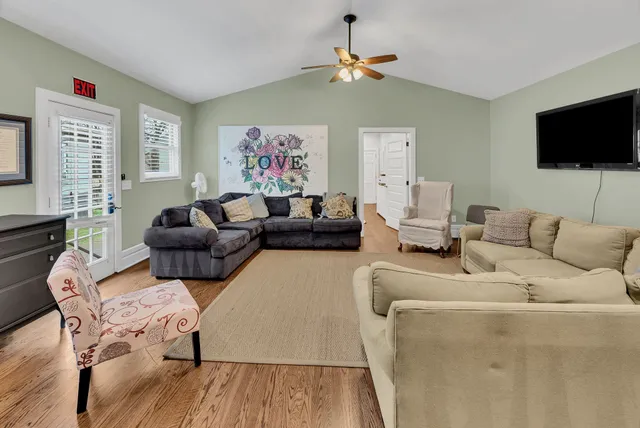 a living room with furniture and a flat screen tv
