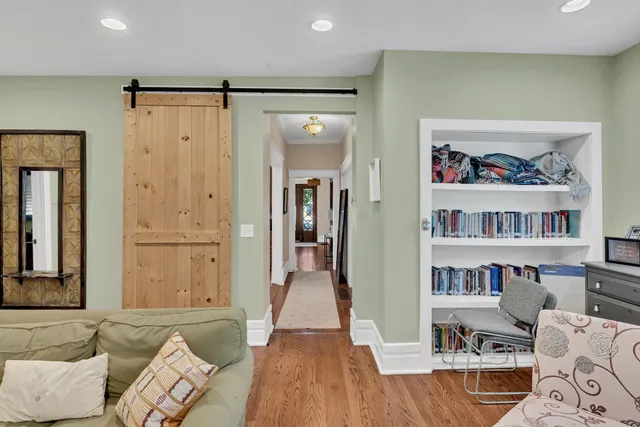 a living room with furniture and a book shelf