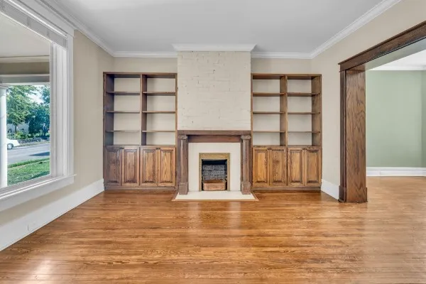 a view of a livingroom with a fireplace and window