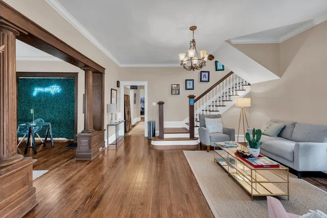 a living room with furniture and wooden floor