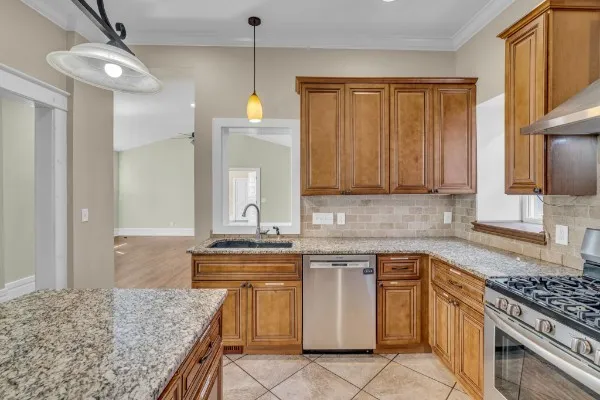 a kitchen with a sink stove and cabinets