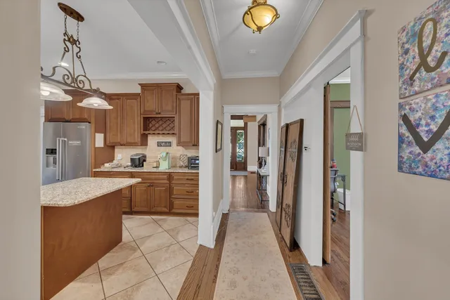 a large kitchen with a sink stainless steel appliances and cabinets