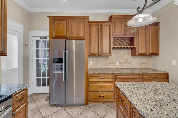 a kitchen with stainless steel appliances granite countertop a refrigerator and microwave