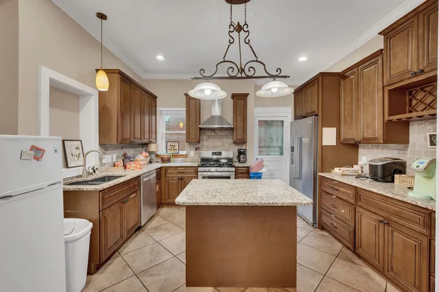 a open kitchen with stainless steel appliances granite countertop a sink stove and refrigerator