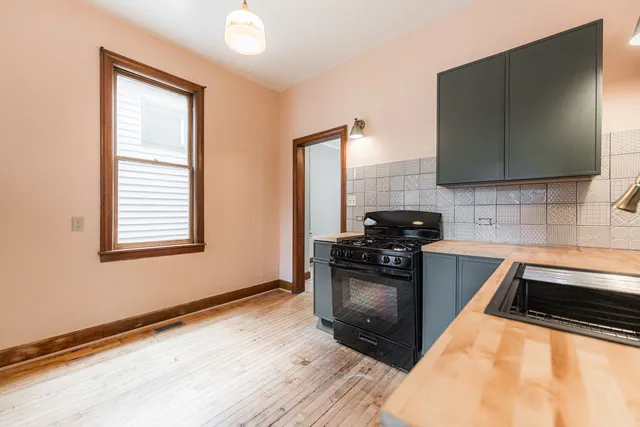 a kitchen with granite countertop a stove and a sink