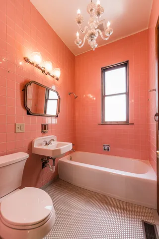 a bathroom with a toilet a sink and bathtub