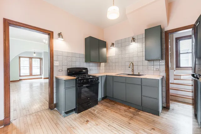 a kitchen with stainless steel appliances granite countertop a stove and a sink