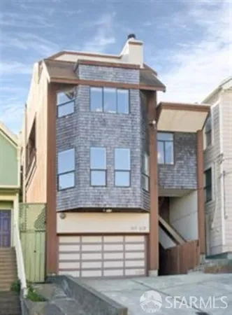 a front view of a house with a garden