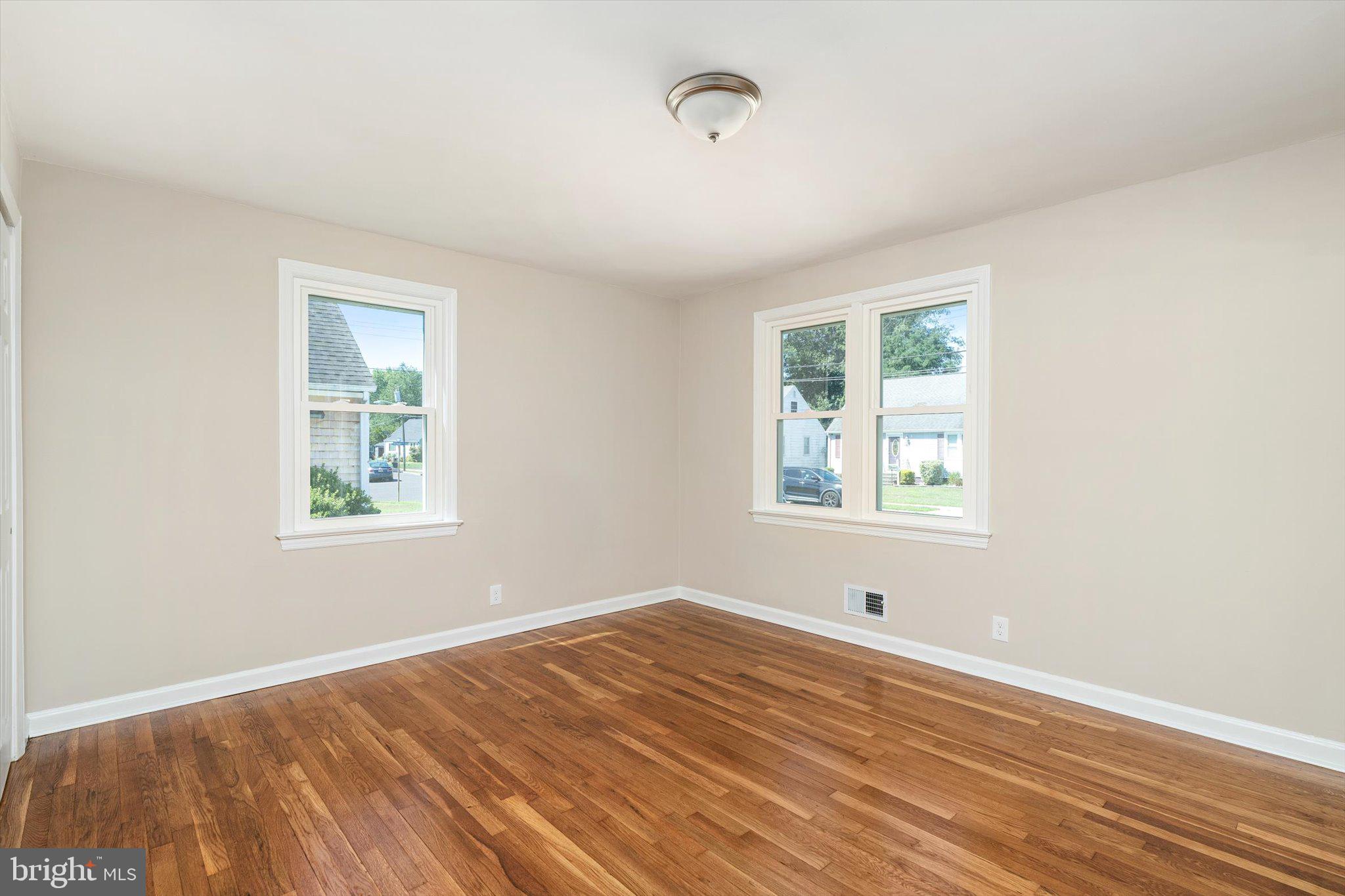 40 Unwin Drive Hamilton, NJ 08610 - Photo 12 of 26 a view of an empty room with wooden floor and a window
