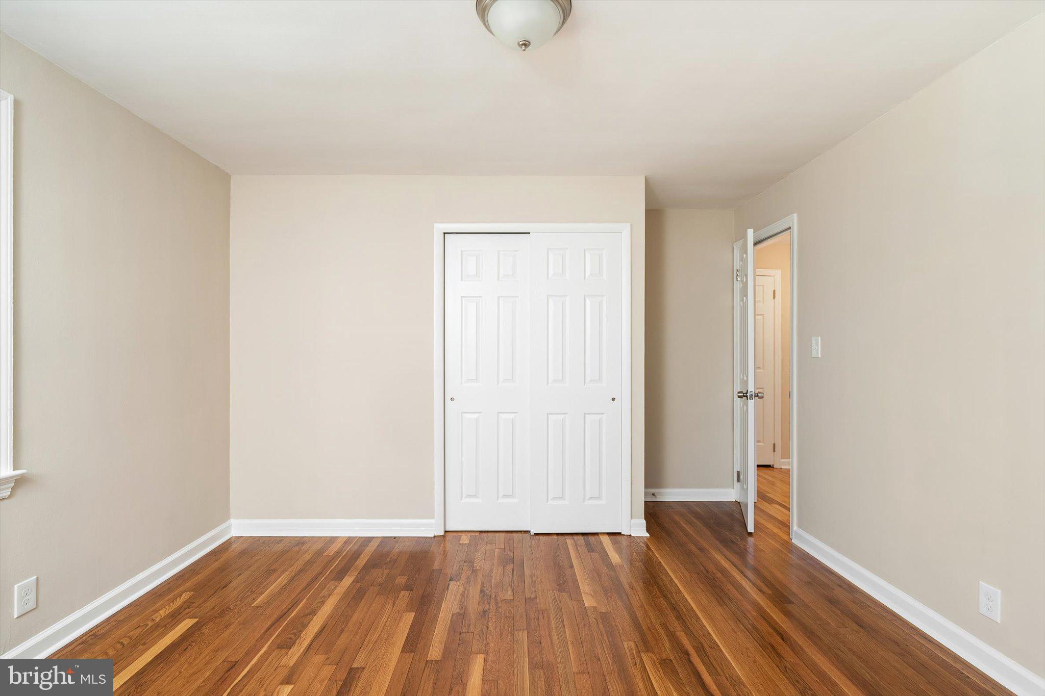 40 Unwin Drive Hamilton, NJ 08610 - Photo 14 of 26 a view of an empty room with wooden floor and a window