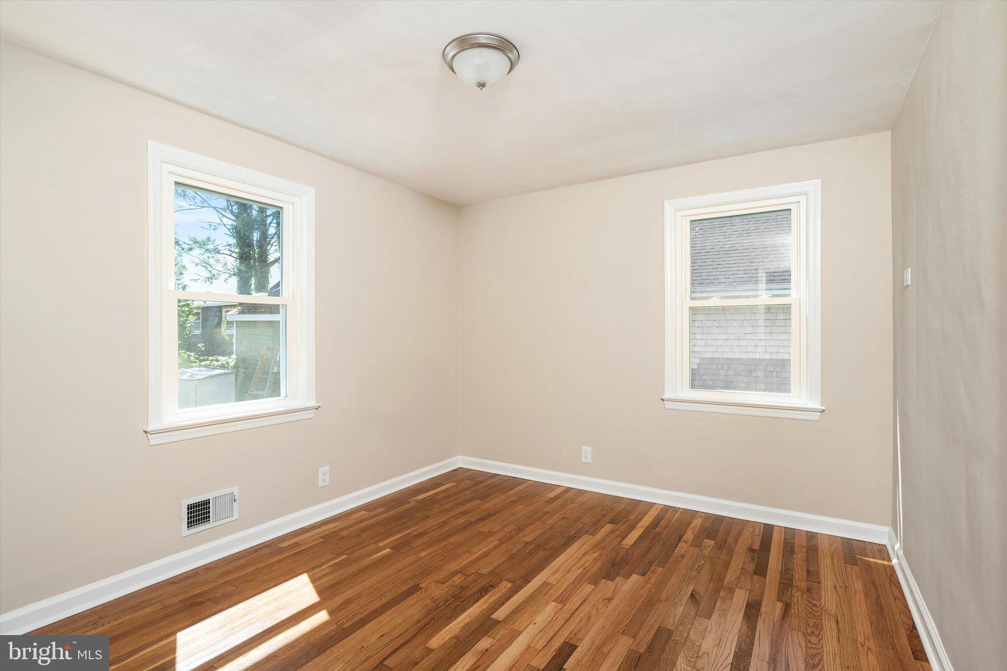 40 Unwin Drive Hamilton, NJ 08610 - Photo 15 of 26 a view of an empty room with wooden floor and a window