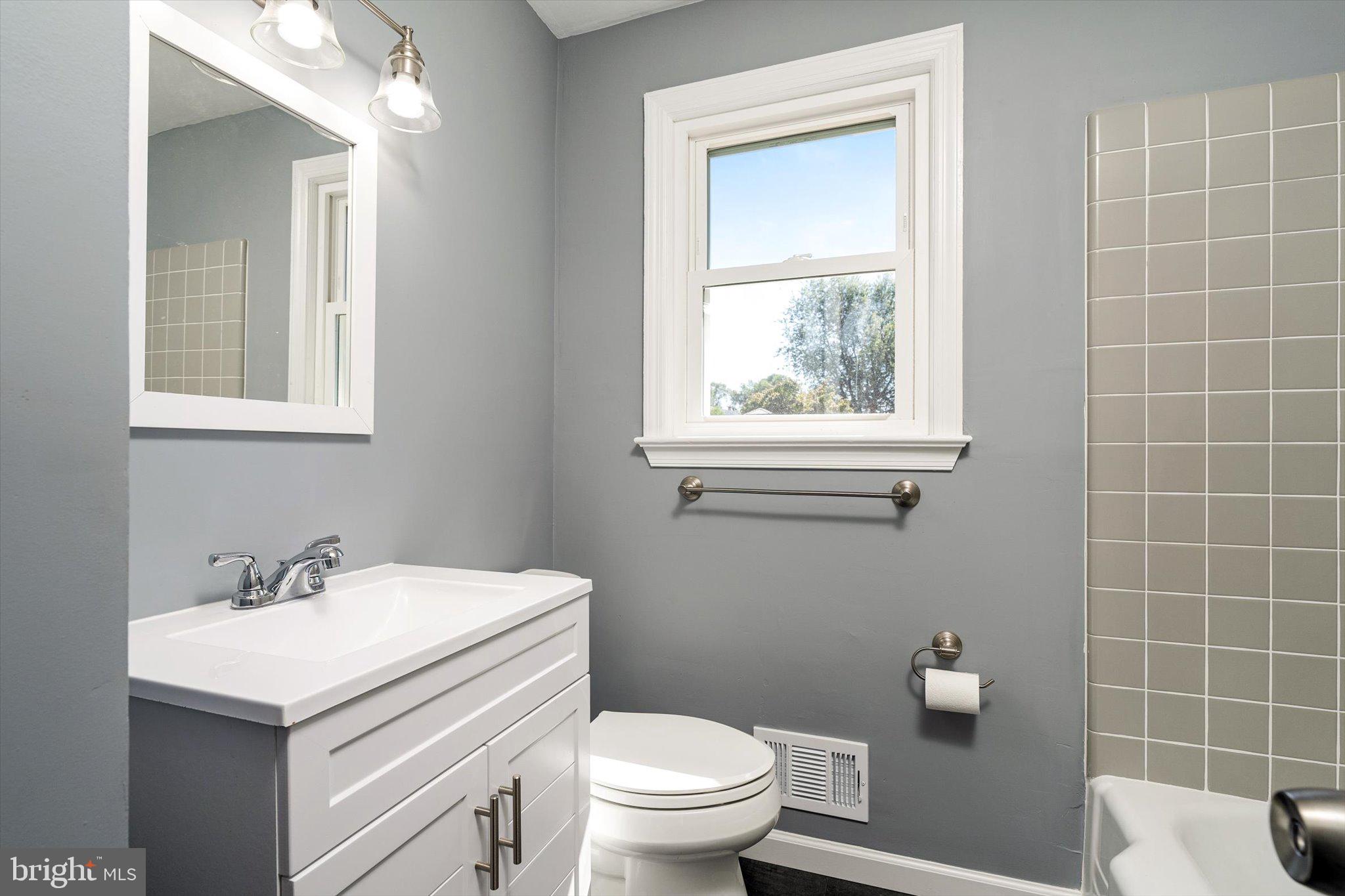 40 Unwin Drive Hamilton, NJ 08610 - Photo 17 of 26 a bathroom with a sink a toilet and a mirror