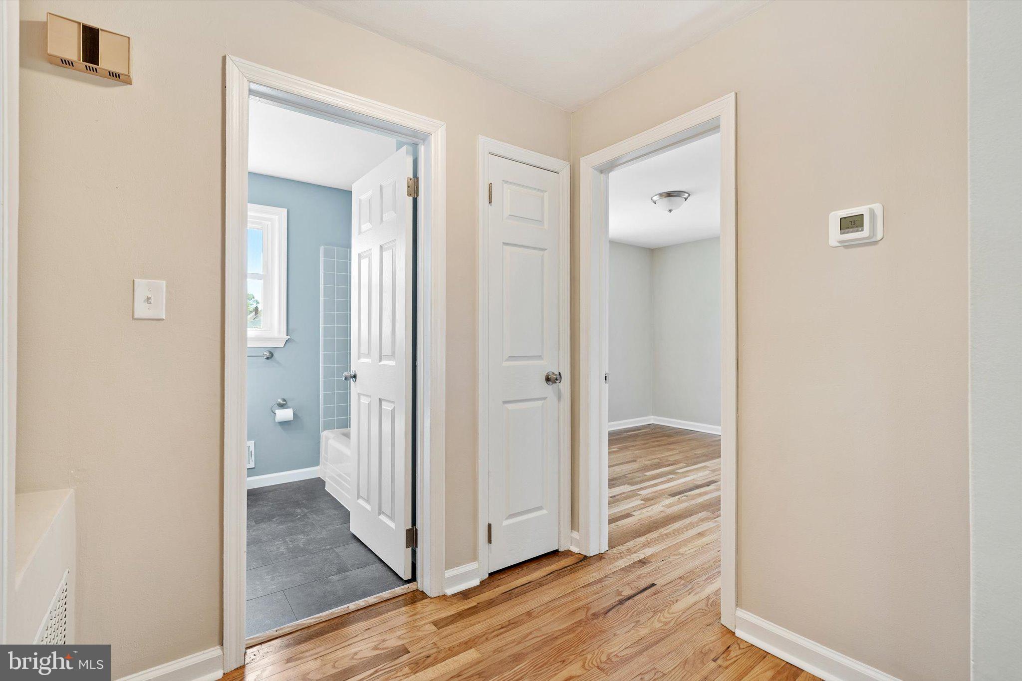 40 Unwin Drive Hamilton, NJ 08610 - Photo 19 of 26 a view of a bathroom from a hallway with wooden floor and a bathroom