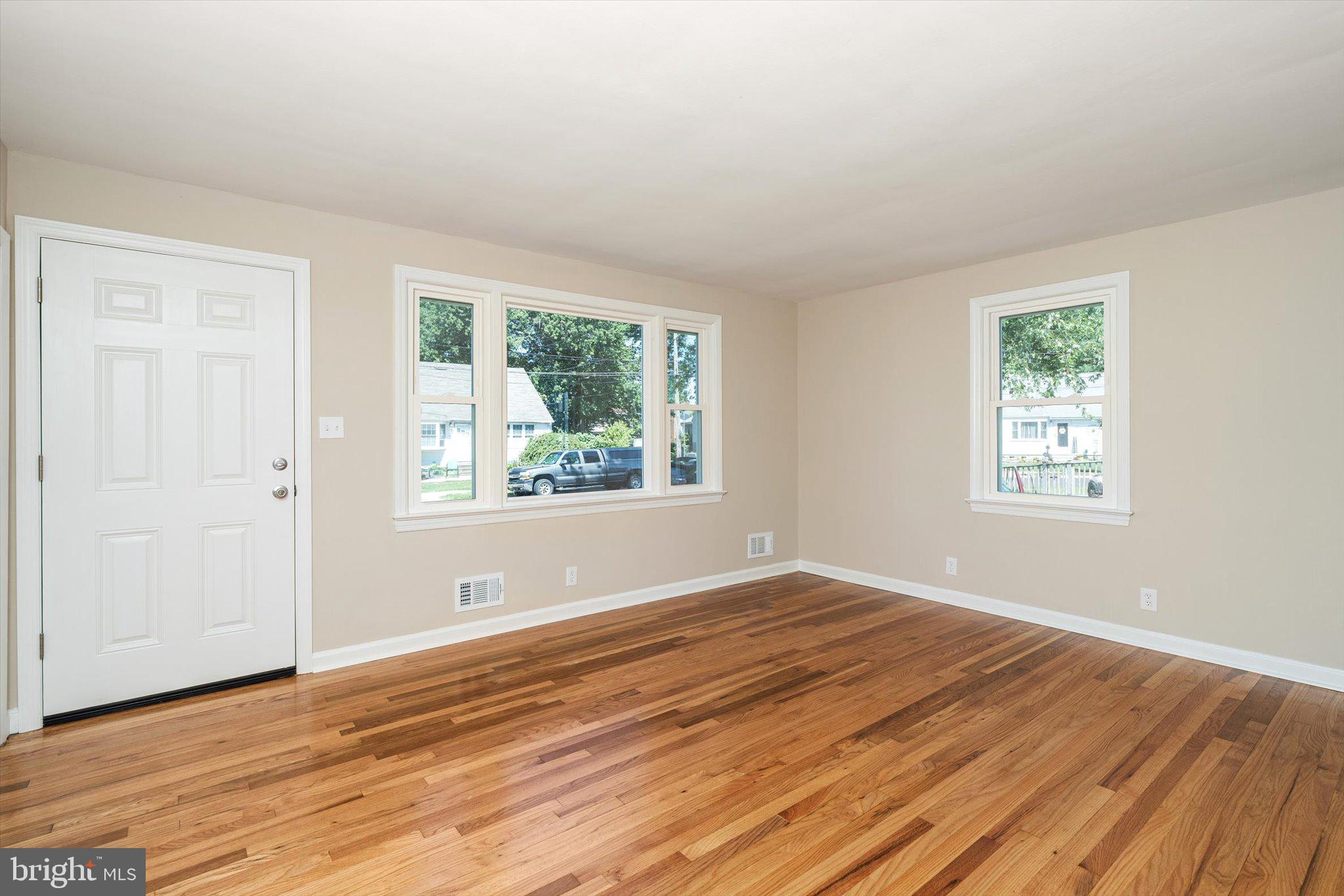 40 Unwin Drive Hamilton, NJ 08610 - Photo 6 of 26 a view of empty room with wooden floor and fan