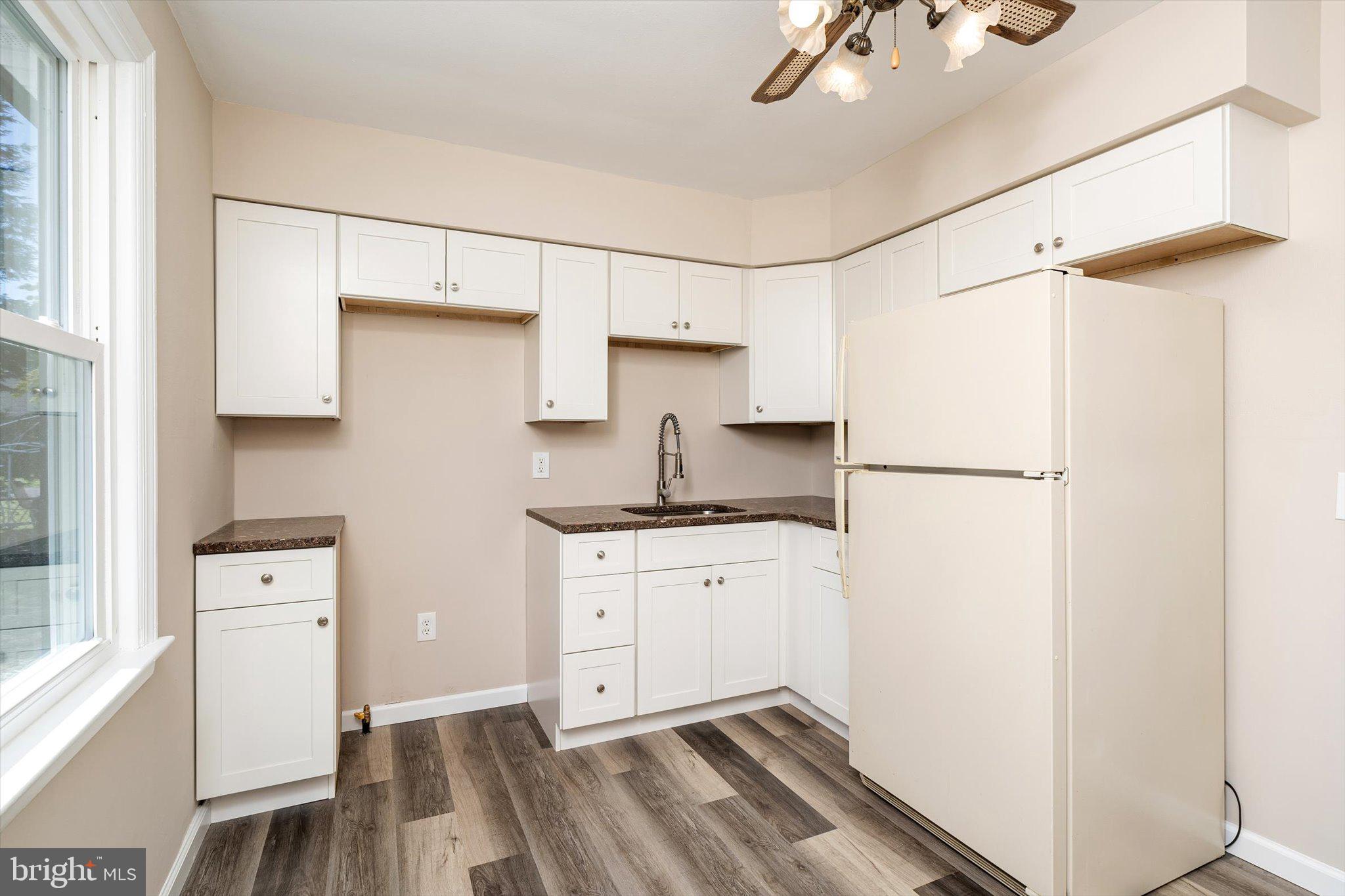 40 Unwin Drive Hamilton, NJ 08610 - Photo 9 of 26 a kitchen with stainless steel appliances granite countertop a refrigerator sink and white cabinets