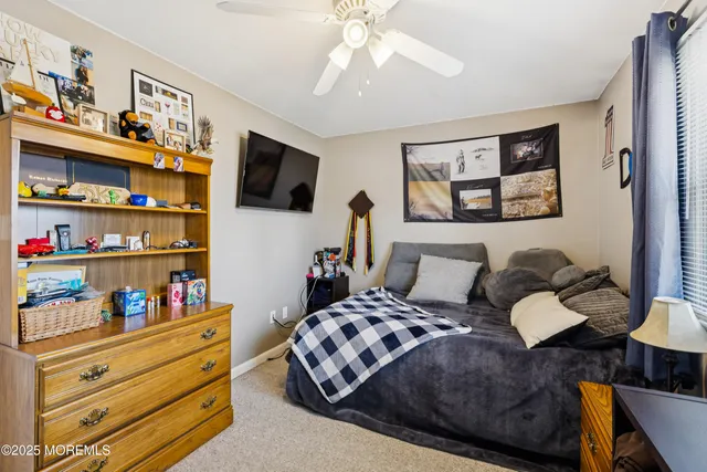 a bedroom with a bed and a bookshelf