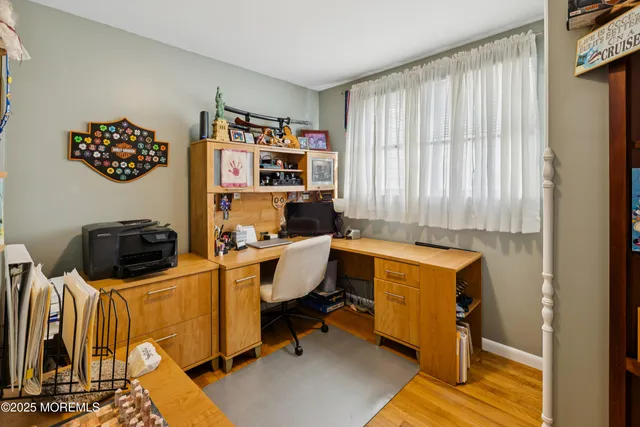 a view of a workspace with furniture and a window